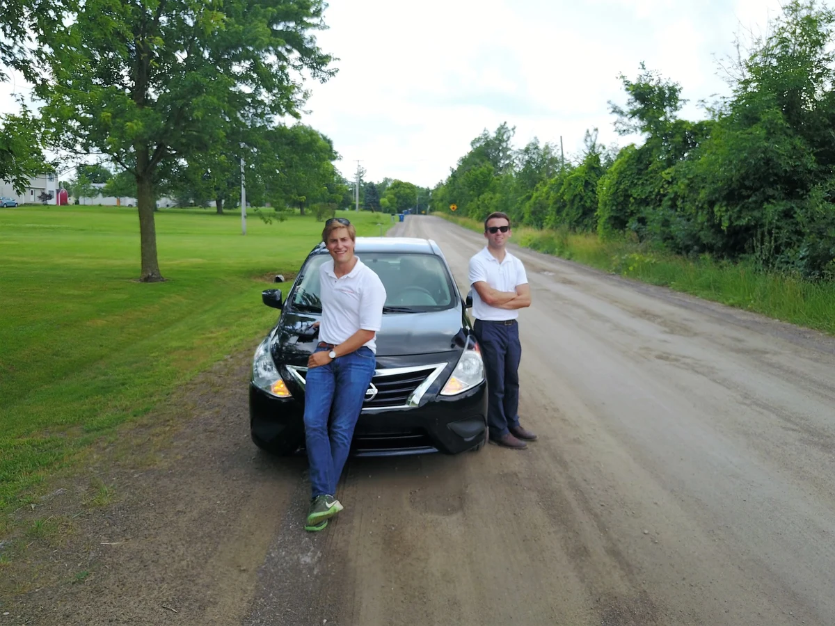Victor and Corey beside a car on a rural road in the early days of Sun2o Partners